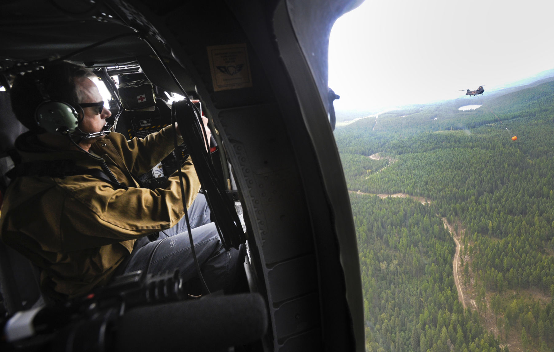 Gov. Steve Bullock takes a photo of a CH-47 Chinook